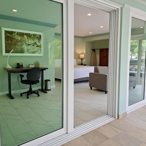 a sliding glass door leading to a bedroom with a desk at P V near Colomitos Beach Boutique Hotel in Puerto Vallarta