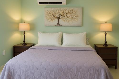 a bedroom with a large bed with two lamps at P V near Colomitos Beach Boutique Hotel in Puerto Vallarta