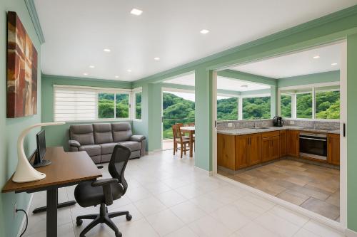 an office with green walls and a table and chairs at P V near Colomitos Beach Boutique Hotel in Puerto Vallarta