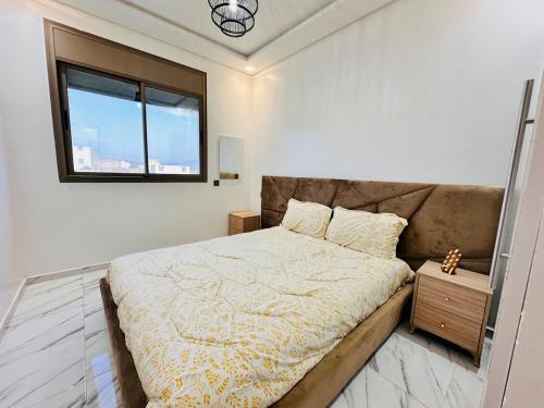 a bedroom with a large bed with a window at Happy Monkey Villa Taghazout in Aït Ahmed