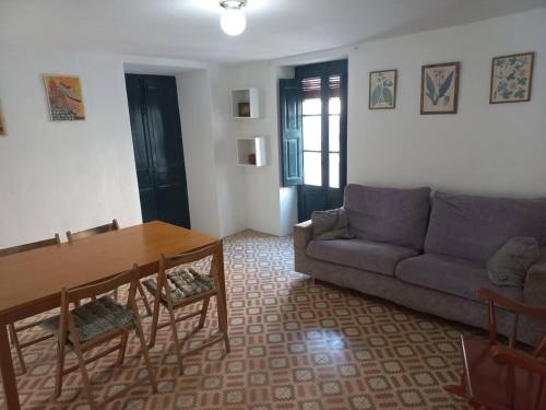 a living room with a couch and a table at Cal Teixidor in Mediona