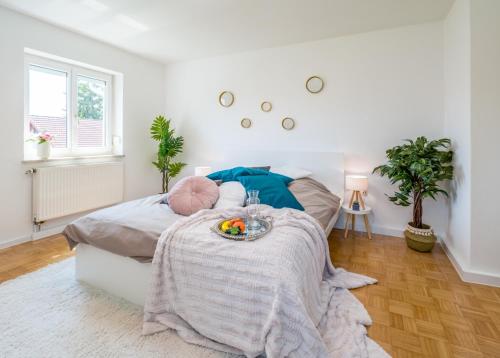 a bedroom with a bed with a tray of fruit on it at EG M City Wohnung nähe Salzburg in Freilassing