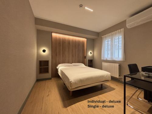 a bedroom with a bed and a window at Pensión Begoña - centro ciudad in Bilbao
