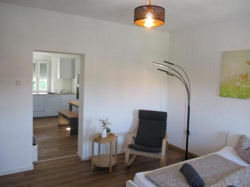 a living room with a couch and a chair at Parsberger City Rooms 104 in Parsberg