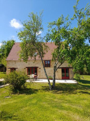 a house with a tree in front of it at Le Lys in Fajoles