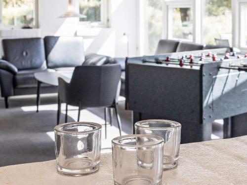 two glasses sitting on a table next to a foos ball at Renovated Retreat near Beach - By Traum Ferienwohnungen in Blåvand