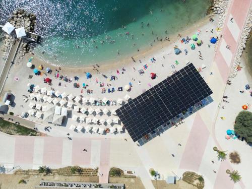 an overhead view of a beach with a group of people at Seaside Apartments, Znjan Beach in Split