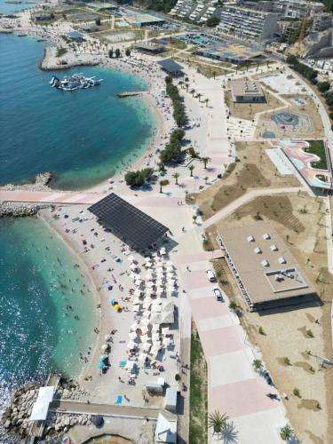 an aerial view of a beach with umbrellas and the ocean at Seaside Apartments, Znjan Beach in Split