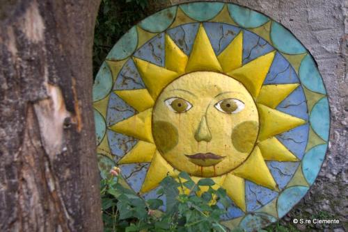 a painting of a sun on the side of a tree at Hotel Del Sole Al Plebiscito in Sapri