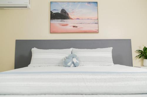 a bed with a stuffed animal on top of it at Lignum Vitae with Pool - Kingston - Budget Stay in Kingston