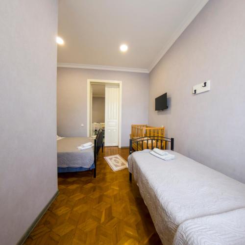 a small room with two beds and a television at Dimitris Cabin In surami in Surami