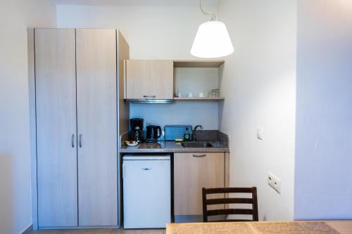 a small kitchen with a counter and a refrigerator at Your Memories Hotel in Gouves