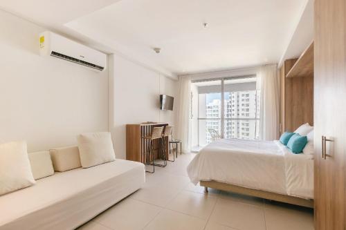 Ένα ή περισσότερα κρεβάτια σε δωμάτιο στο U-GO Edificio Ambar Roca en Rodadero Sur