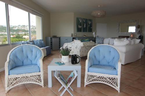 two chairs and a table in a living room at Lagoon Terrace Penthouse with sea view in Plettenberg Bay