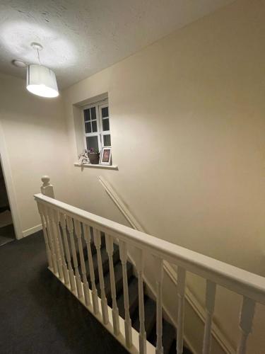 a room with a staircase and a window at John Lennon airport guests house in Liverpool
