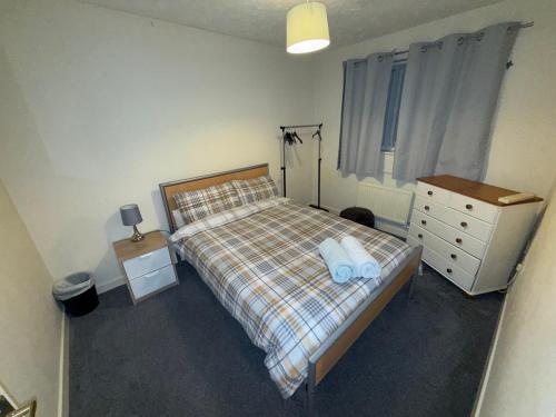 a bedroom with a bed and a dresser at John Lennon airport guests house in Liverpool