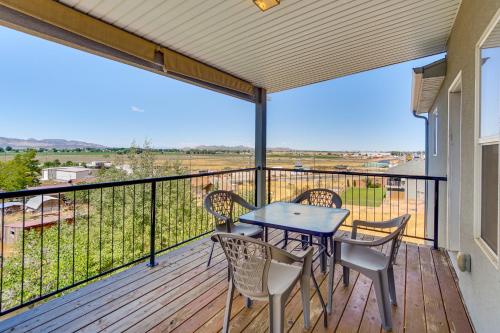a patio with a table and chairs on a balcony at Panoramic Views Spacious Home in Cedar City! in Cedar City