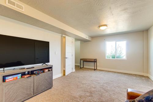a living room with a large flat screen tv at Panoramic Views Spacious Home in Cedar City! in Cedar City