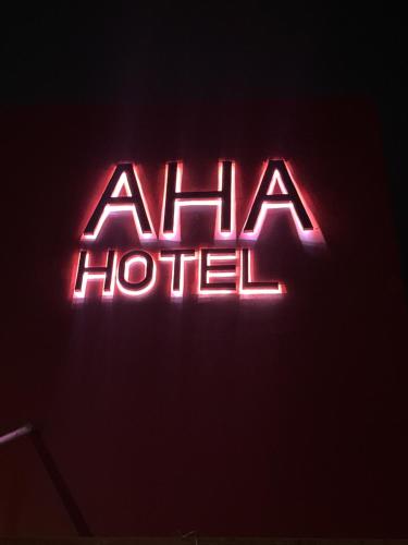 a neon sign that says alma hospital on a wall at AHAhotel 
