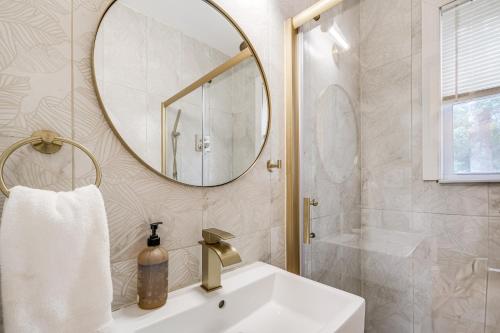 un bagno con lavandino e specchio di 1 Mi to Arts District Modern Hyattsville Hideaway a Hyattsville