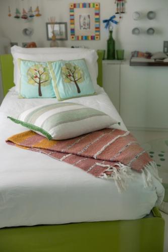 a bed with two pillows on top of it at Magic Forte in Forte dei Marmi