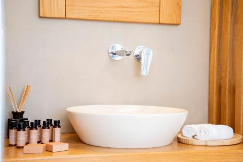 a white bowl on a counter with a sink at Due Mari Mykonos in Agios Ioannis Mykonos