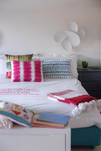 a bedroom with a bed with books on it at Magic Forte in Forte dei Marmi