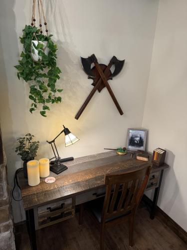 a wooden desk with a clock on a wall at The Ancient Bears Den By Avada Properties in Union Grove