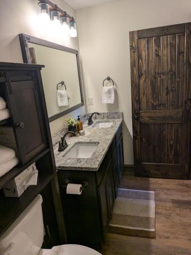 a bathroom with a sink and a large mirror at The Ancient Bears Den By Avada Properties in Union Grove