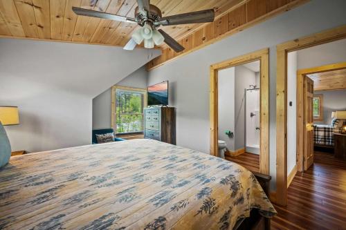 a bedroom with a bed and a ceiling fan at Rustic Retreat By Avada Properties in Greystone Heights