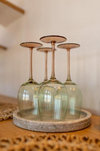 three glass vases sitting on top of a table at Oasis Village Eforie Nord in Eforie Sud