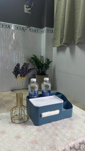 a blue lunch box with two water bottles on a table at Lam NguyenVn Minihouse in Can Tho