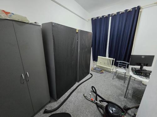 a room with two black cabinets and a desk at Rooms by Southgate Station Budget Mid to Long Term Stay in East Barnet