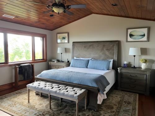 a bedroom with a large bed and a wooden ceiling at Hot Tub and Stunning Views Luxury Beech Mtn Escape! in Beech Mountain