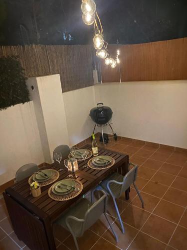 a dining room with a table and chairs and a chandelier at Tropical House in Carvoeiro