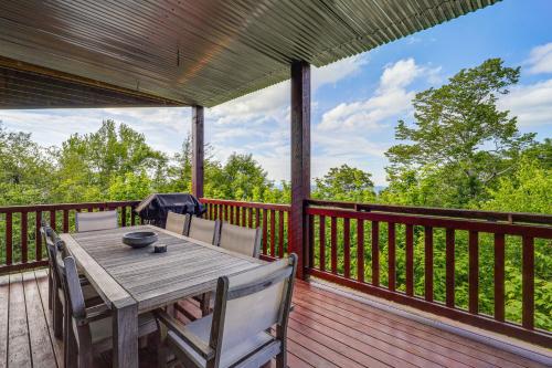 a wooden table and chairs on a deck at Hot Tub and Stunning Views Luxury Beech Mtn Escape! in Beech Mountain