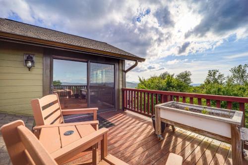 a deck with a piano and chairs on a house at Hot Tub and Stunning Views Luxury Beech Mtn Escape! in Beech Mountain