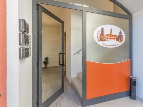 an open door in a room with an orange door at Nour Apartments - Castramajora Alloggi in Casalmaggiore