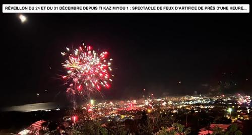a fireworks display over a city at night at Vaste logement spa vue superbe Ti Kaz Miyou 1 in La Possession
