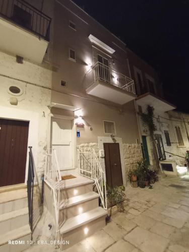 a building with stairs leading to a door and a balcony at Schinosa 30 luxury room in Bisceglie