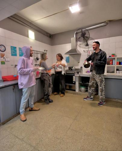a group of people standing in a kitchen at Play Hostel Soho in Buenos Aires