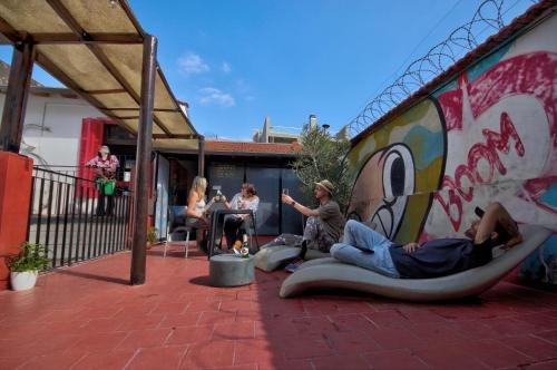 a group of people sitting on chairs on a patio at Play Hostel Soho in Buenos Aires