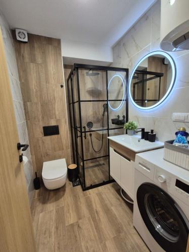 a bathroom with a shower and a toilet and a sink at Skyline Panorama in Vrnjačka Banja
