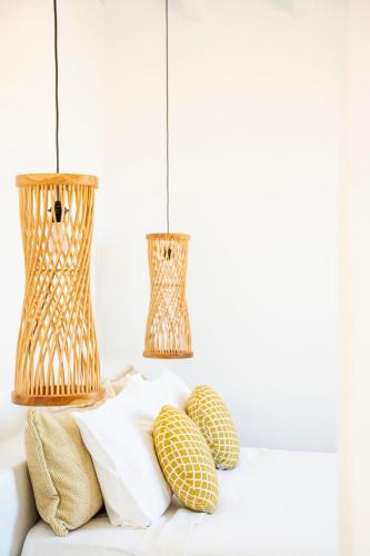two lamps on top of a couch with pillows at Due Mari Mykonos in Agios Ioannis Mykonos
