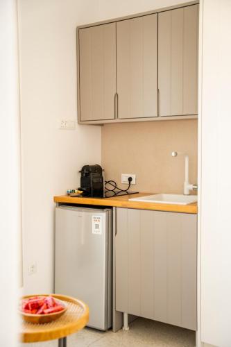 a kitchen with a sink and a refrigerator at Due Mari Mykonos in Agios Ioannis Mykonos
