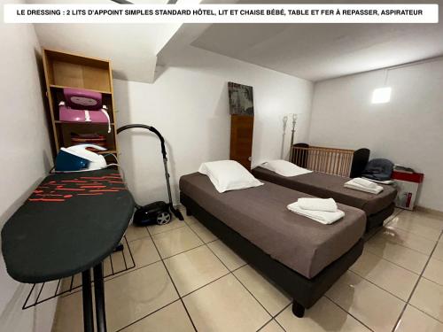 a room with two beds and a chair in it at Vaste logement spa vue superbe Ti Kaz Miyou 1 in La Possession