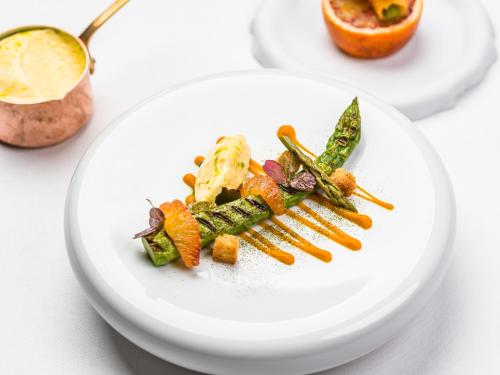 a plate of food with vegetables on a table at Chateau d'Audrieu in Audrieu