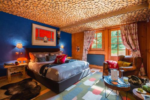 a bedroom with a bed and a table and a chair at Magic Megève Bois in Demi-Quartier