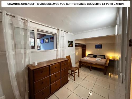 a bathroom with a sink and a table in a room at Vaste logement spa vue superbe Ti Kaz Miyou 1 in La Possession