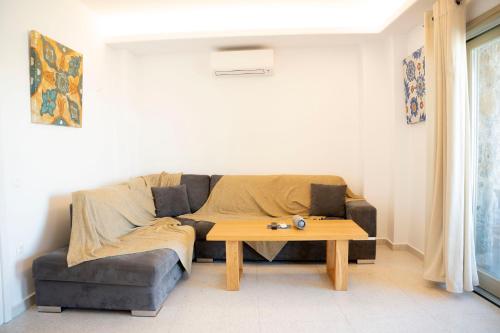 a living room with a couch and a coffee table at Due Mari Mykonos in Agios Ioannis Mykonos